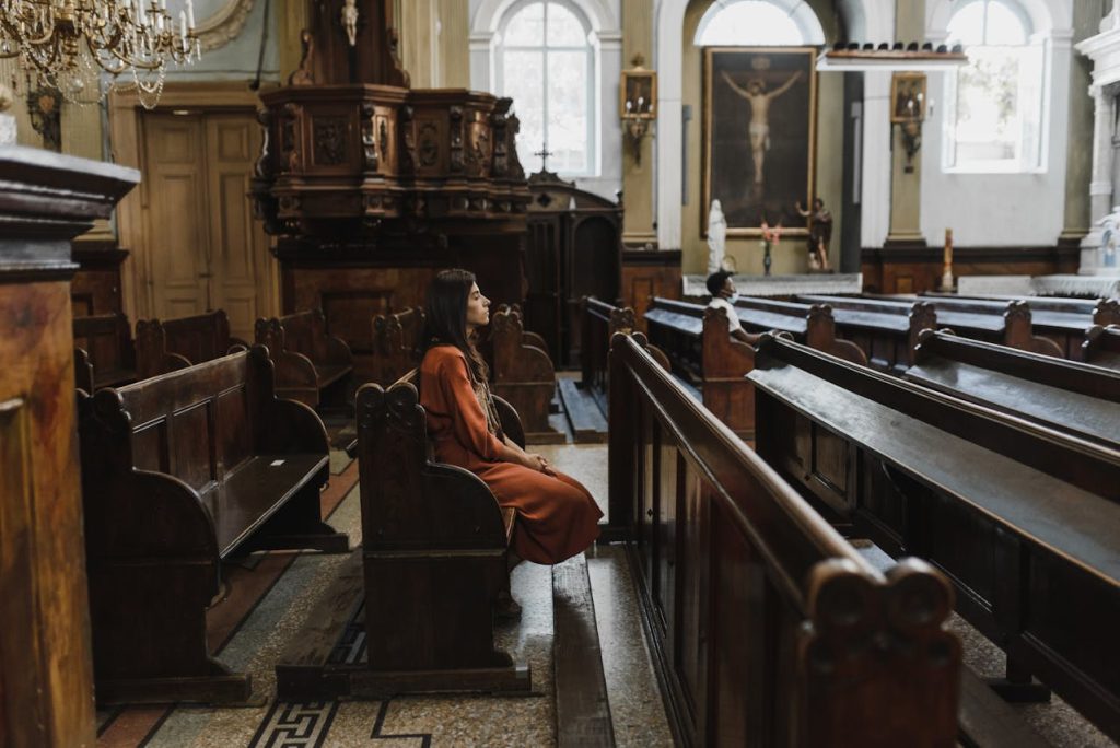 Solo traveler sitting quietly in a tiny chapel