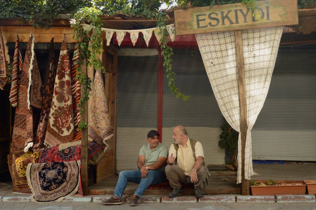 Men Sitting on Street in Town