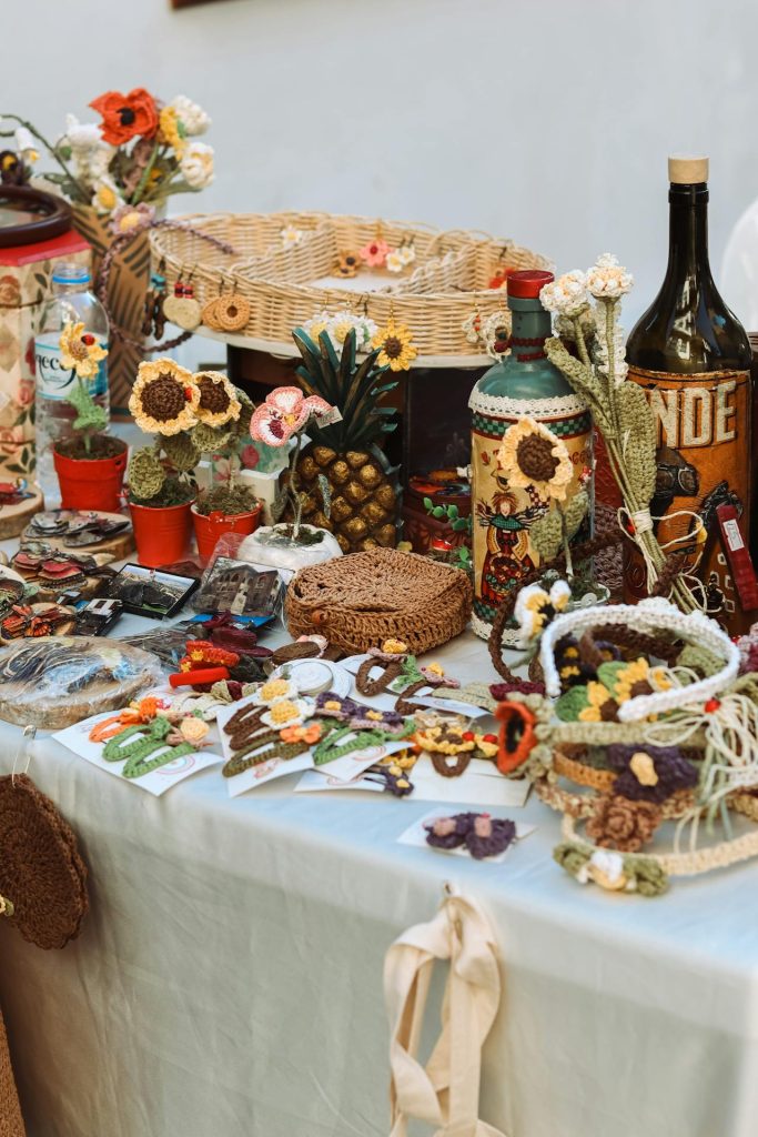 A table of handcrafted sweetgrass baskets and ornaments displayed by local artisans.
