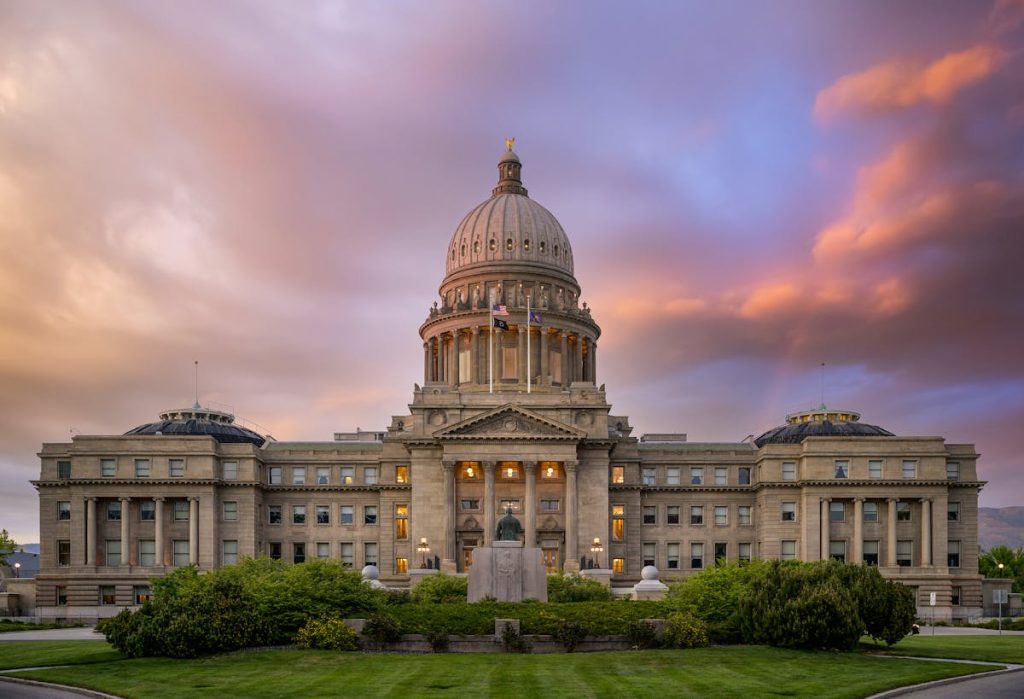 Facade of aged historic cathedral under colorful sky at sunset