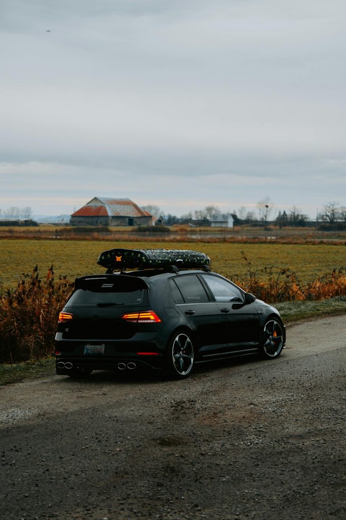A car driving down a quiet countryside road