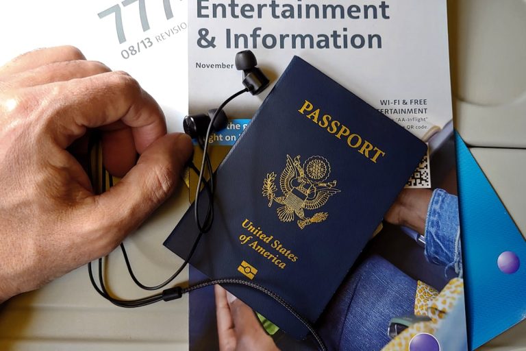 US Passport with Travel Essentials on Airline Seat