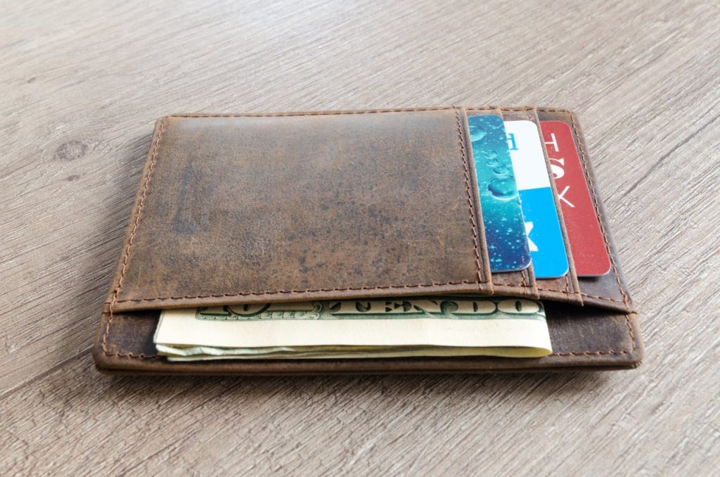 Brown Leather Wallet and Us Dollar Banknote
