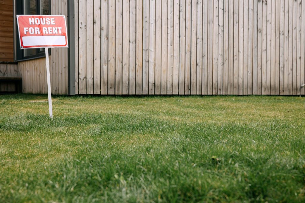 Red Signage on Grass Field