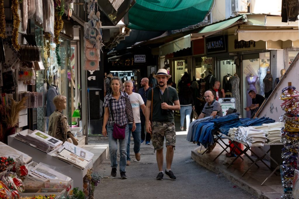 A tourist walking confidently through a busy local market, dressed casually and blending with locals.