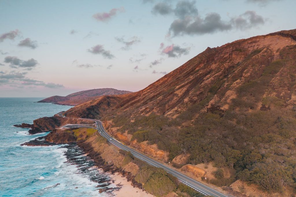 A Road Beside a Mountain and an Ocean 
