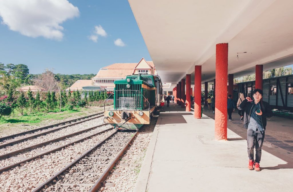 Boy Standing Beside Green Train