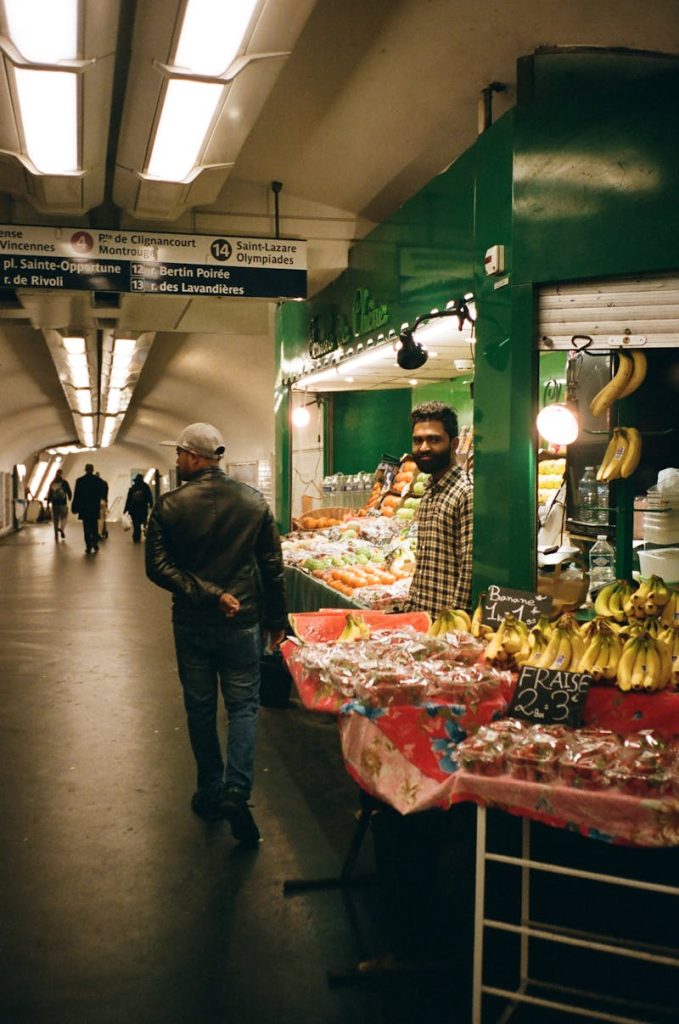 Man Walking Beside Store at Train Station