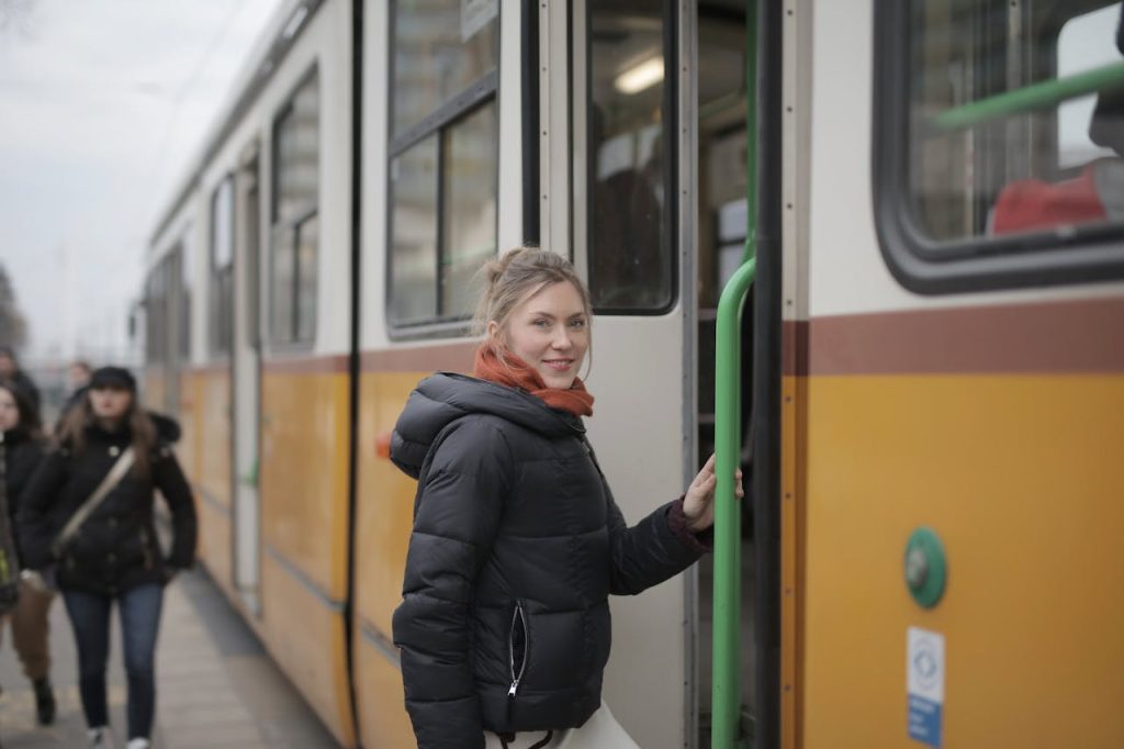 A traveler boarding a metro or tram with a transit pass.