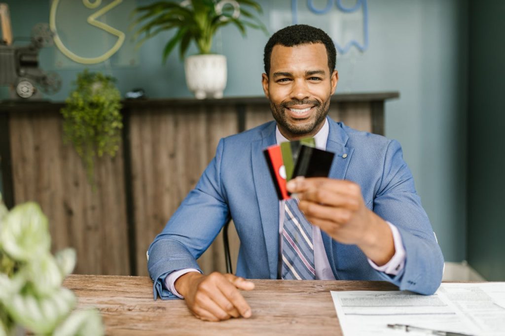 A Man in a Suit Holding Credit Cards
