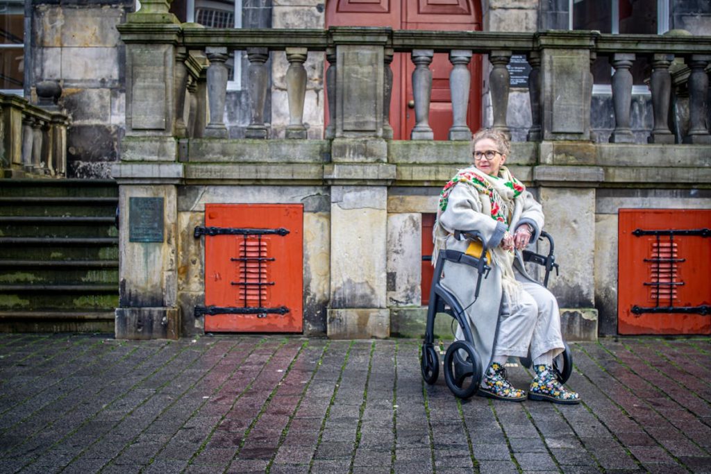 Woman Sitting in Mobility Aid