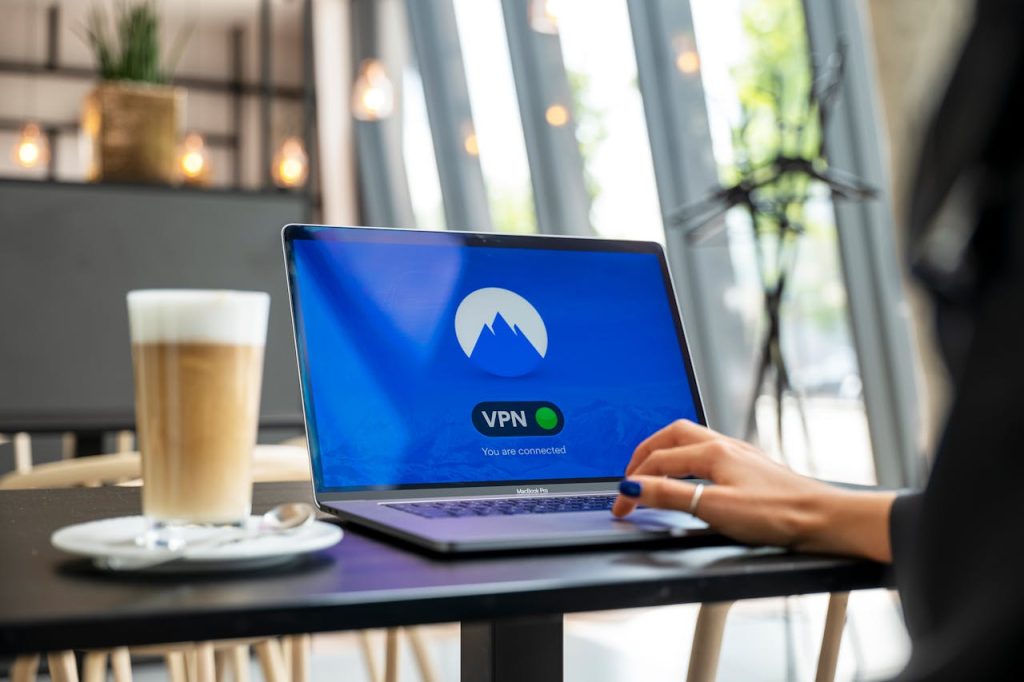 Traveler connecting to Wi-Fi in an airport or café while using a VPN app on their phone or laptop.