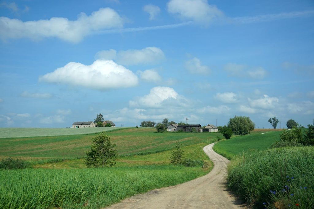 Open fields with distant farmhouses