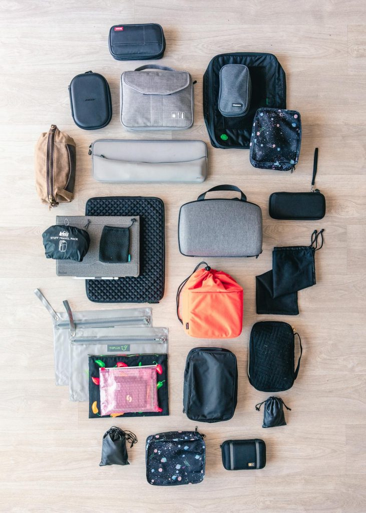 Color coded packing cubes arranged in an open suitcase.