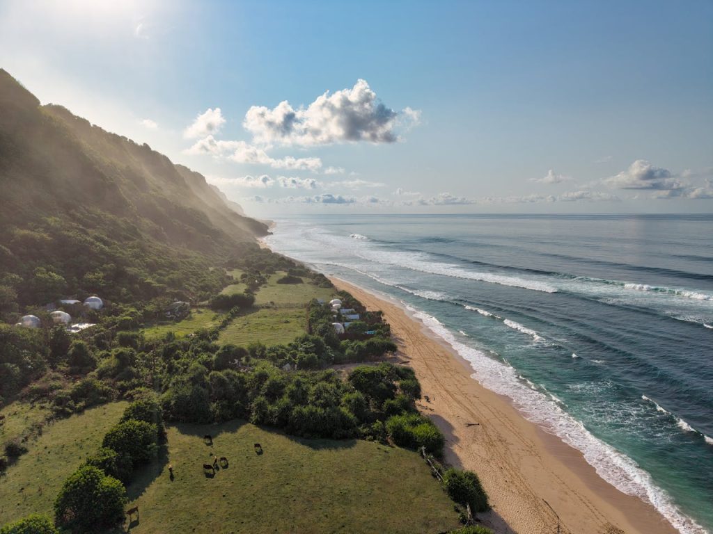 Aerial View of Bali's Stunning Coastline at Sunrise
