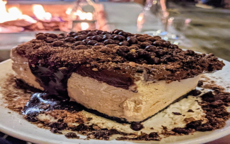 A heavenly slice of Mississippi Mud Pie with coffee ice cream, hot fudge, and an Oreo crust