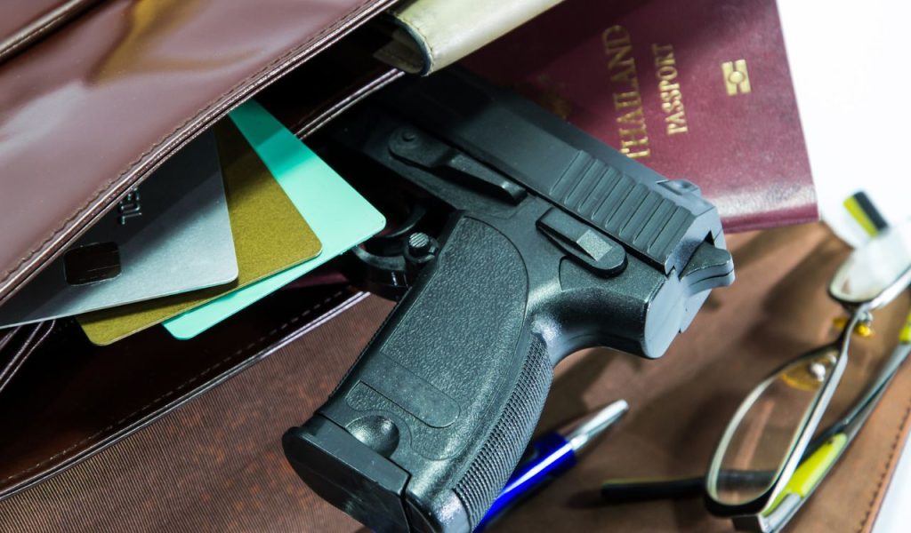 Card,passport and gun in Woman's bag