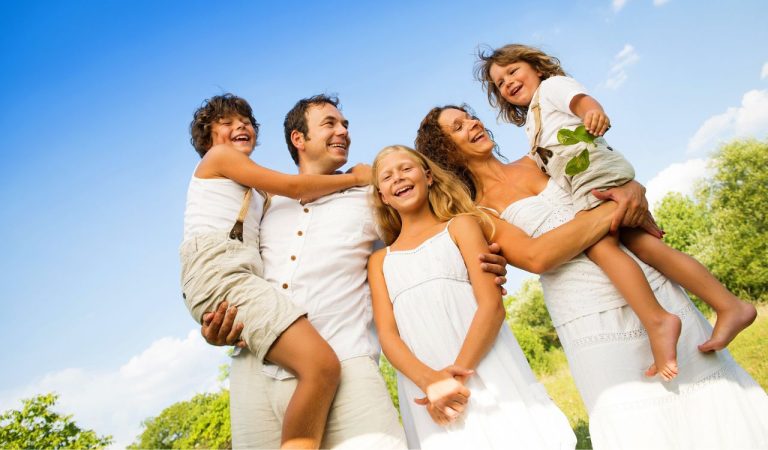 Happy young family spending time outdoor on a summer day