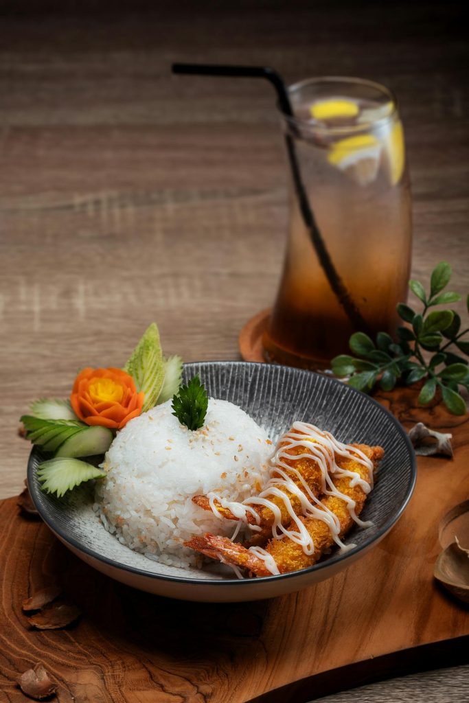 Cooked Rice With Fried Shrimp in Bowl Near Glass of Juice