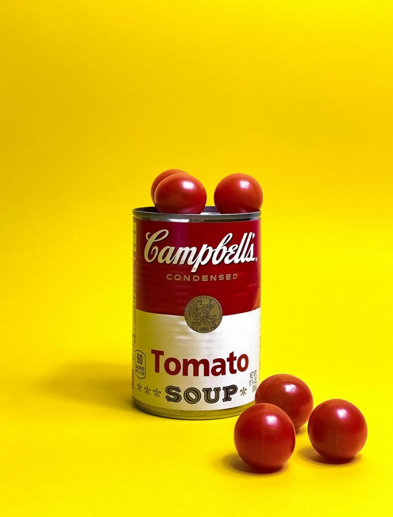 Campbell's tomato soup on a yellow background