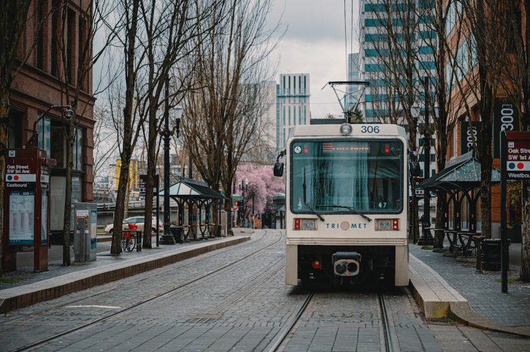 Modern tram riding on city railroad