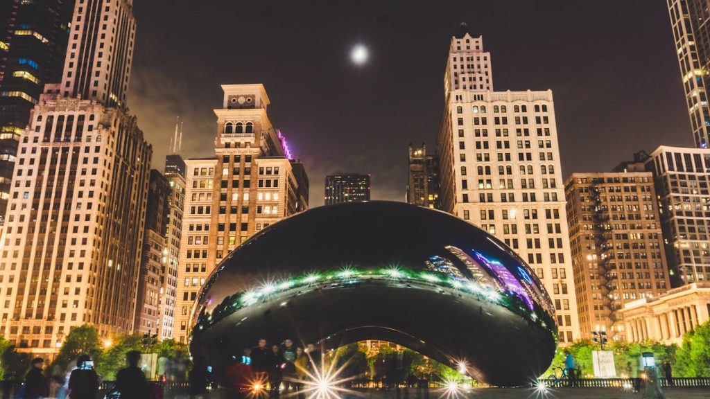 Cloud Gate in Front of High-rise Tower Buildings