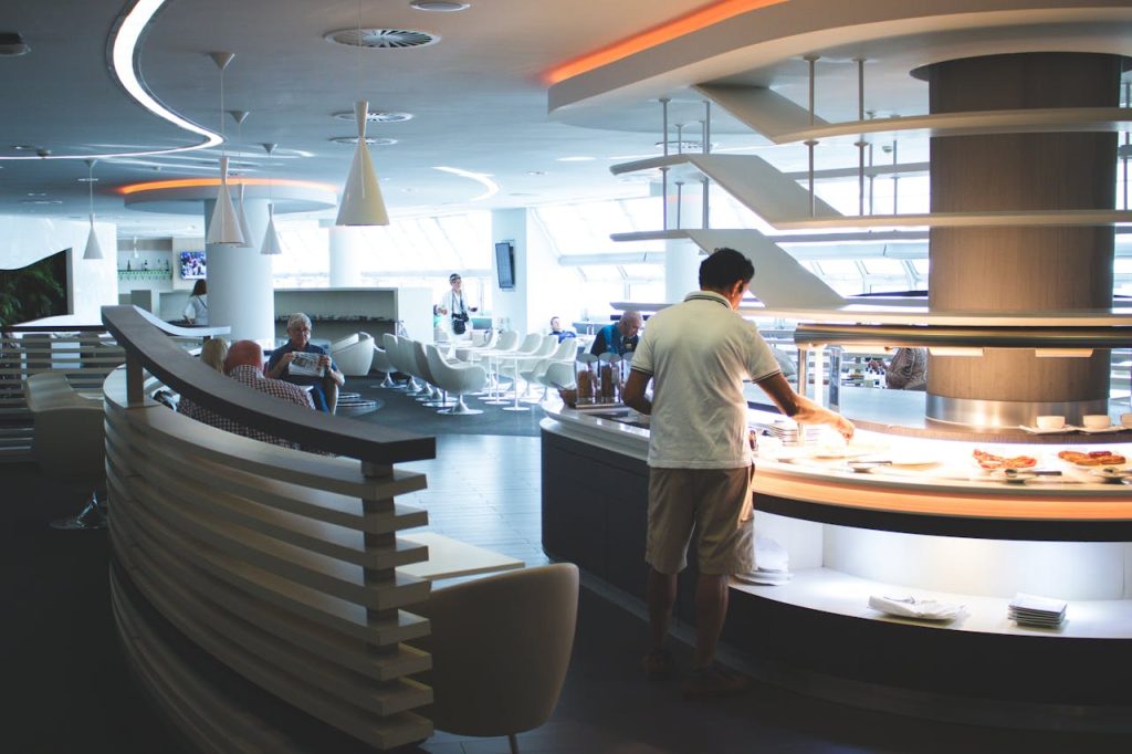 Man In White Collared Top in Airport Restaurants and Bars