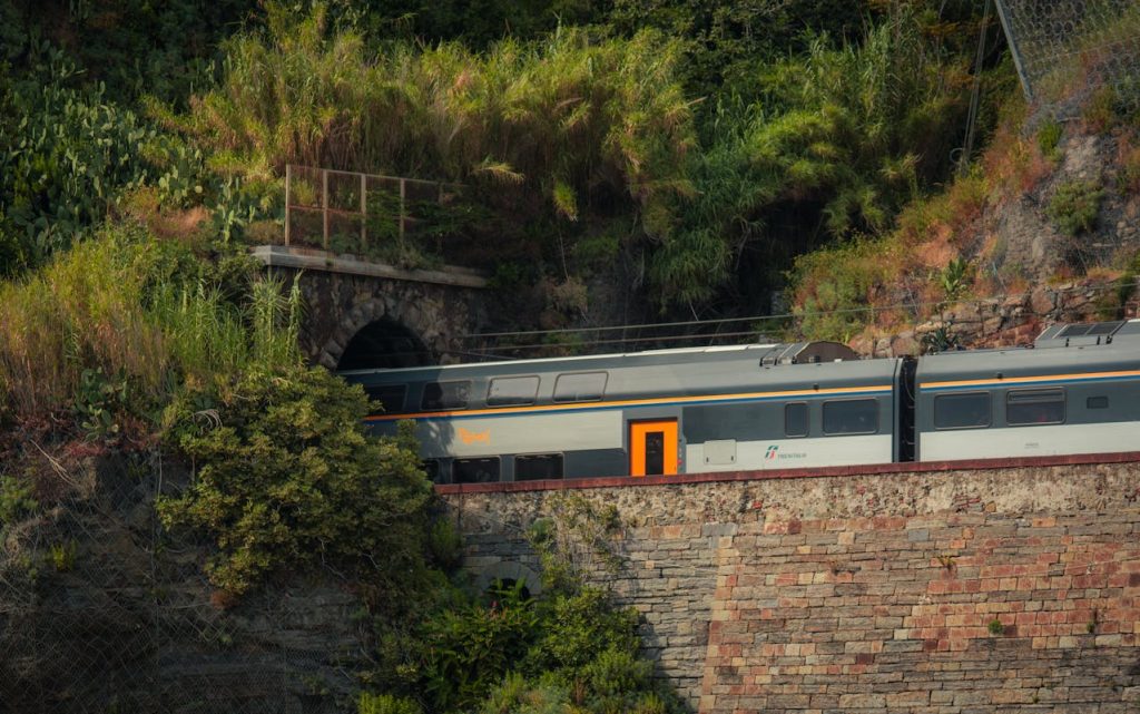 12 Scenic Train Rides in Europe Disrupted by Environmental Tourism Backlash – Her Life Adventures Train Emerging from Tunnel in Vernazza, Italy