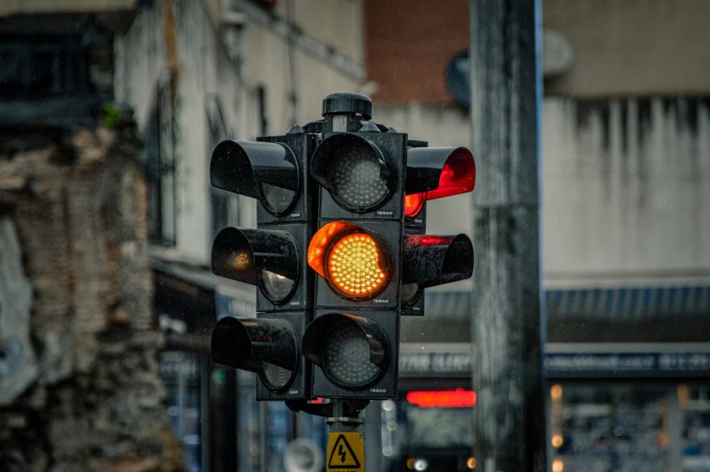 Traffic Light with Amber Signal in Rainy Istanbul