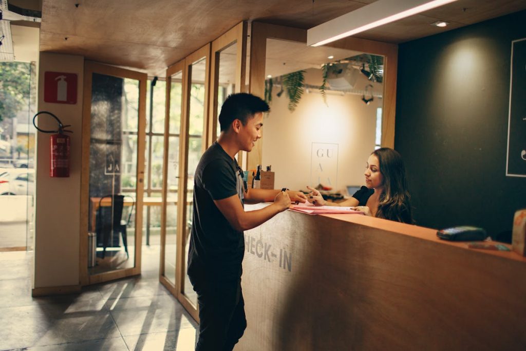 11 Things Hotel Staff Wish Guests Knew Before Checking In – Her Life Adventures Man Standing in Front of Front Desk
