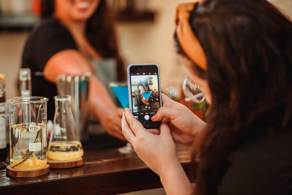 Woman clicking pictures in a Bar