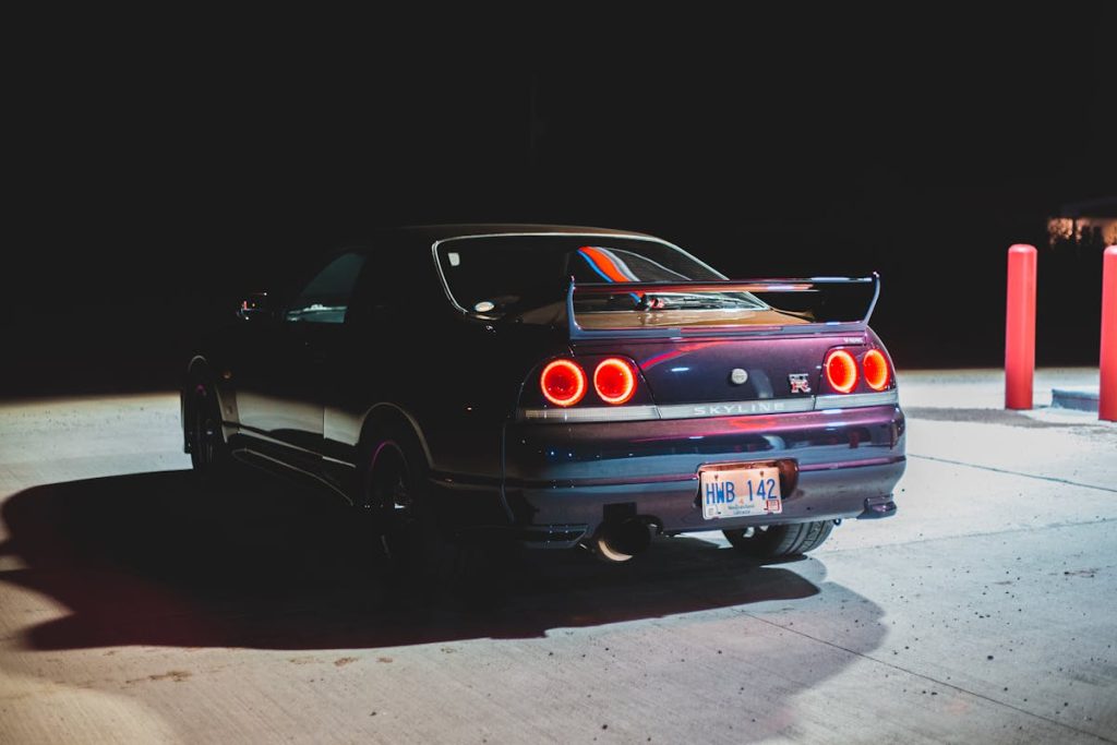 Bright sports auto on pavement in petrol station in twilight