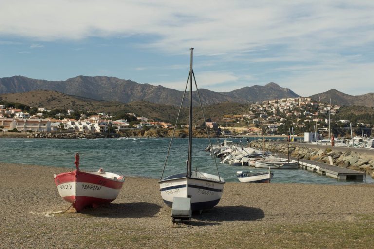 White Red and Black Sail Boat on Gray Sand Roses, Spain