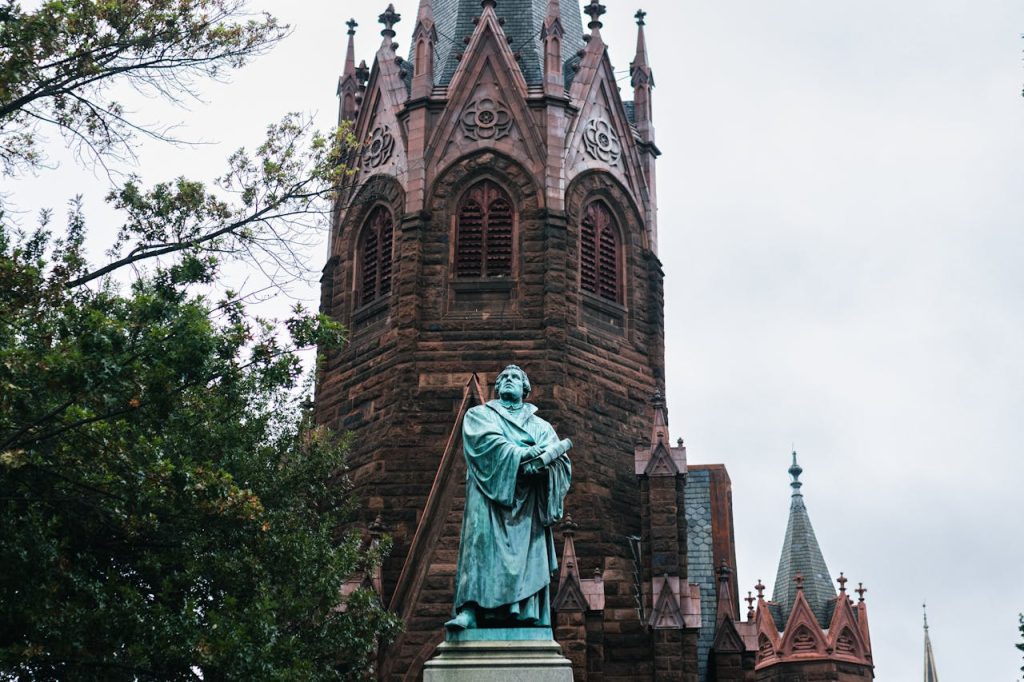 Historic Church with Statuesque Figure and Gothic Architecture