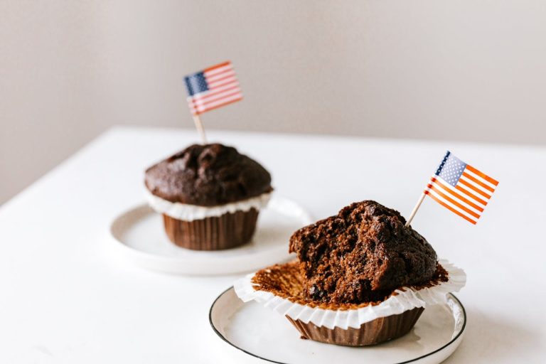 Delicious sweet muffins decorated with toothpick flags of USA