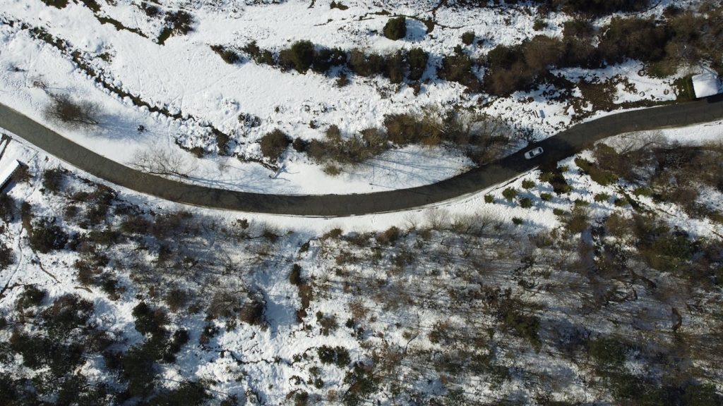 Aerial View of Snowy Road in Winter Landscape