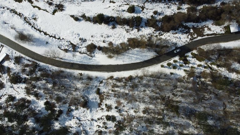 Aerial View of Snowy Road in Winter Landscape