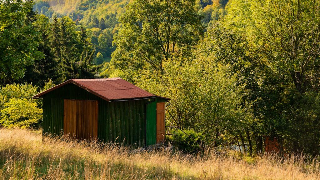 Brown Wooden Cabin on Green Grass Field