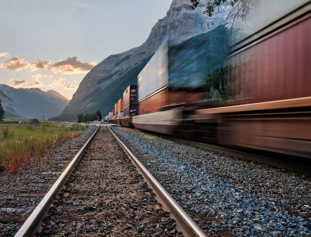A train gliding past mountains or plains