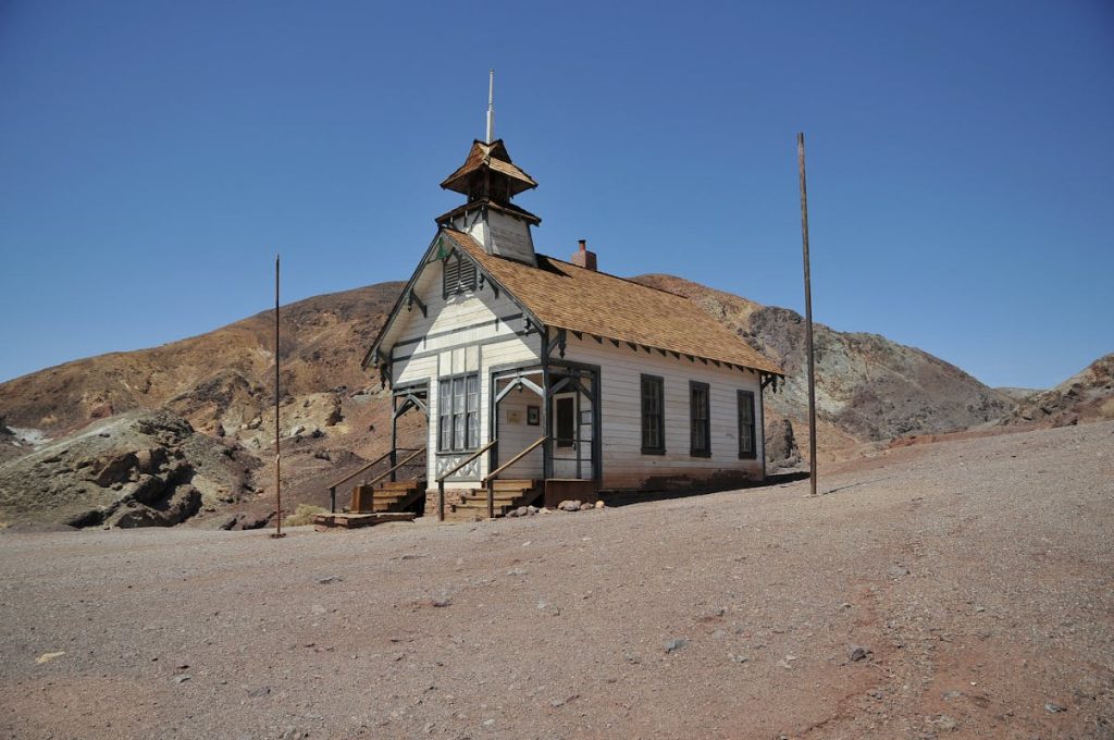 9 Border Crossings That Have Become Ghost Towns in Recent Years – Her Life Adventures Brown and White Concrete House on Brown Sand Under Blue Sky