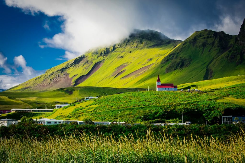 Green Field Near Mountain During Daytime in Vik, Iceland
