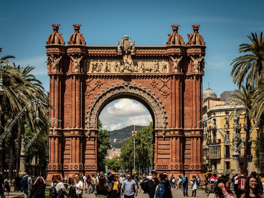 People Standing Near Brown Arched Gate