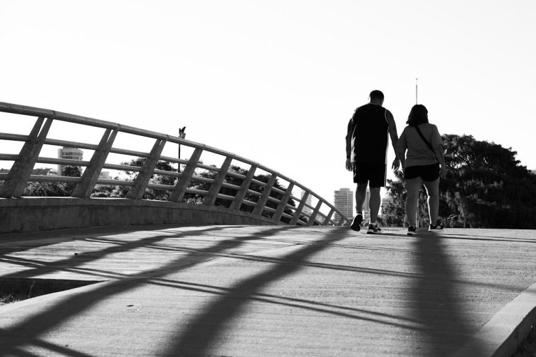 Couple Walking on Bridge in Black and White