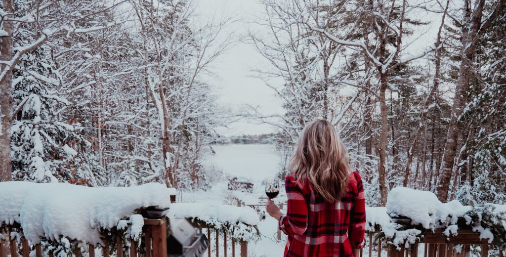 Woman Enjoying Winter Forest with Wine