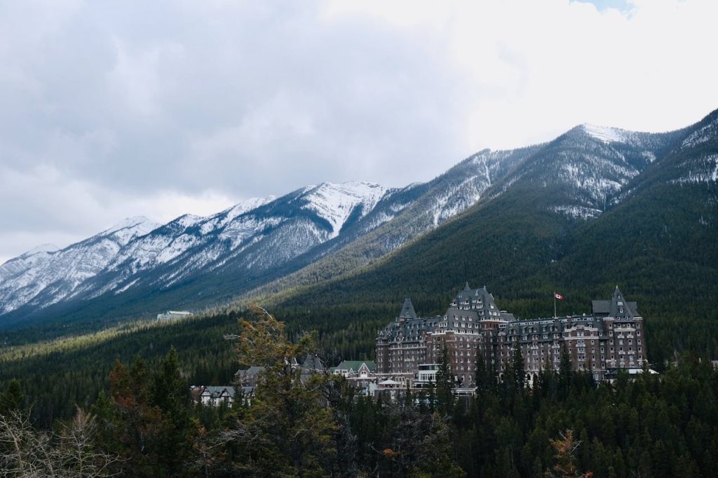 Brown Buildings Surrounded by Green Trees in Banff, AB, Canada