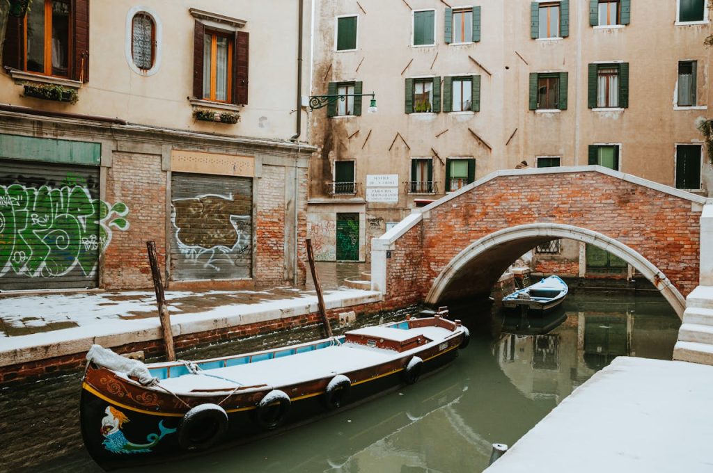 Snow Covered Gondola on a Canal in Venice