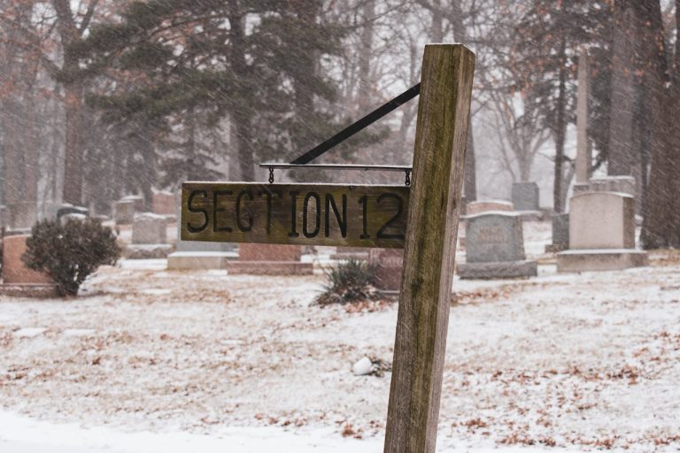 Sign on wooden pillar in winter