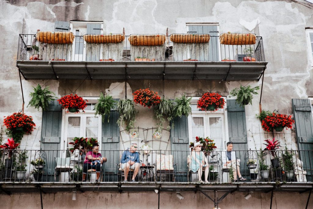 People Sitting on the Balcony of a Building in the French Quarter in New Orleans, Louisiana
