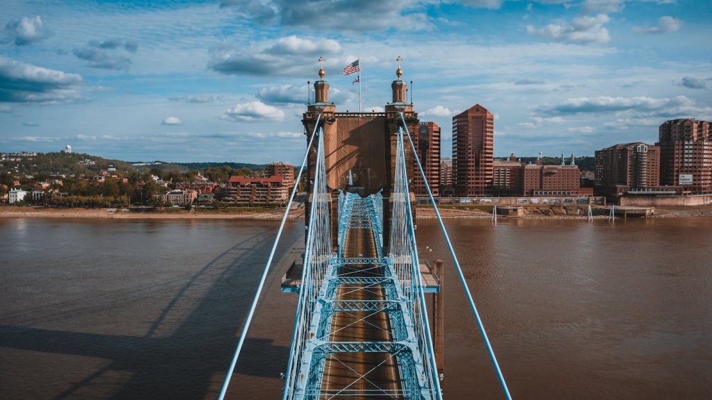 Suspension bridge over river on sunny day,Cincinnati, OH, United States