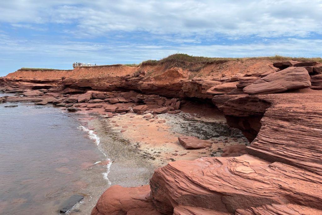 Red Sandstone Bluffs That Bleed Color Into Foam